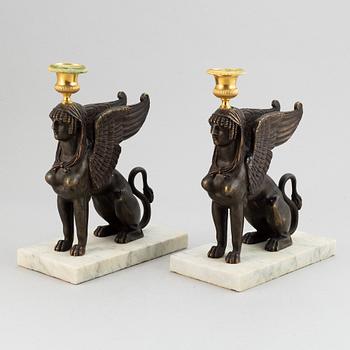 A pair of bronze and marble Empire style candlesticks, first part of the 20th Century.