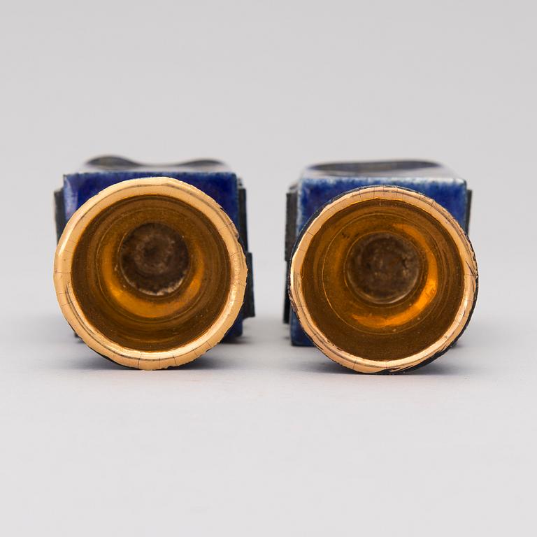 A pair of ceramic candlesticks signed Kaipiainen.