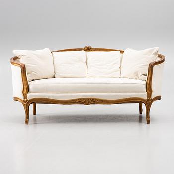 A Louis XV-style sofa, early 20th century.