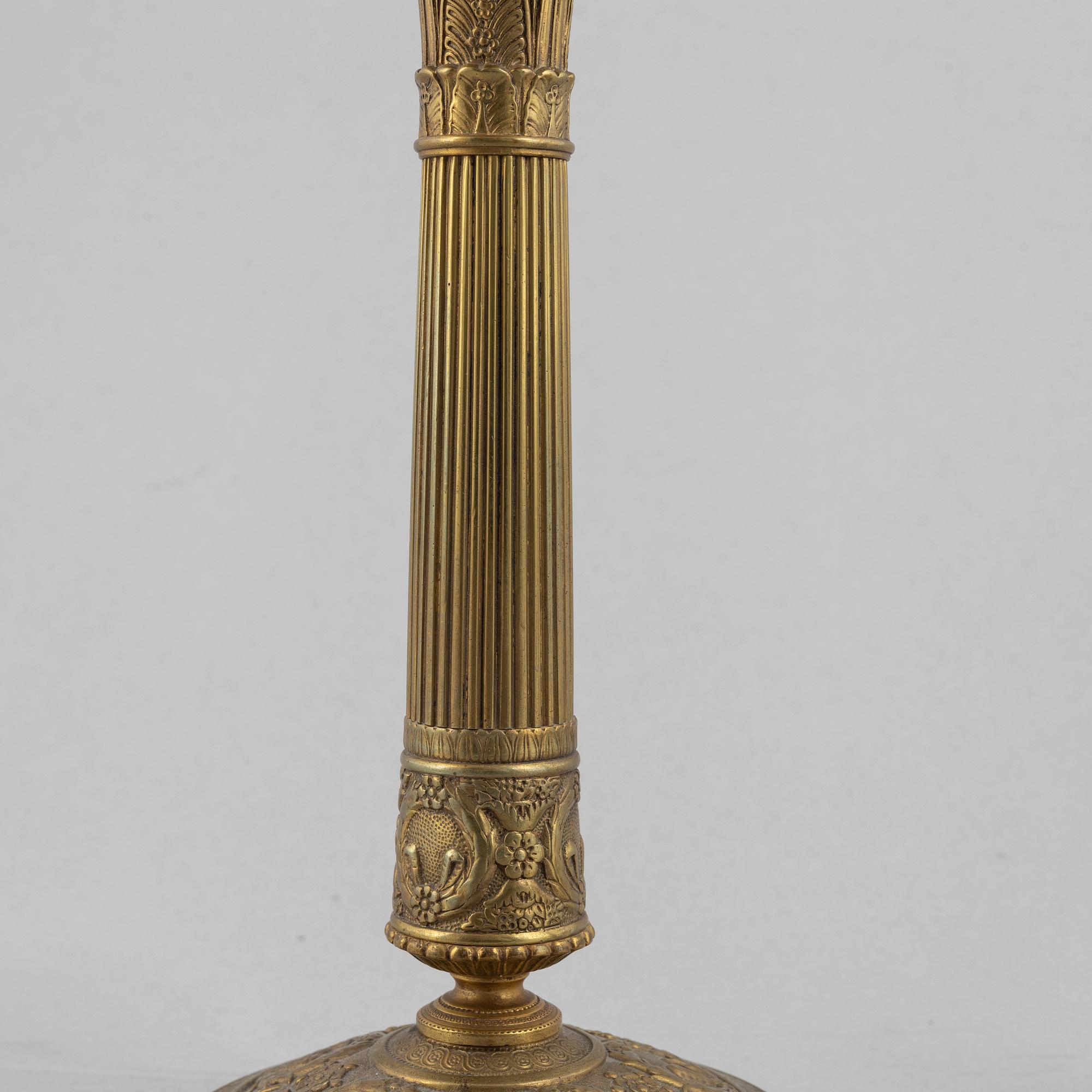 A pair of Empire gilt brass candle sticks, first half of the 20th century.