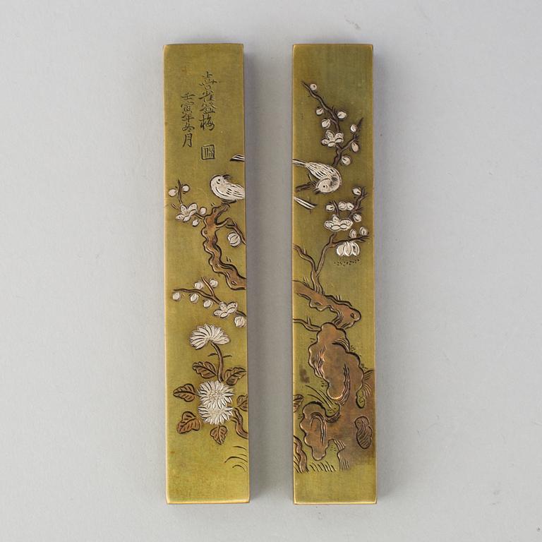 A pair of Japanese scroll weights, early 20th Century.