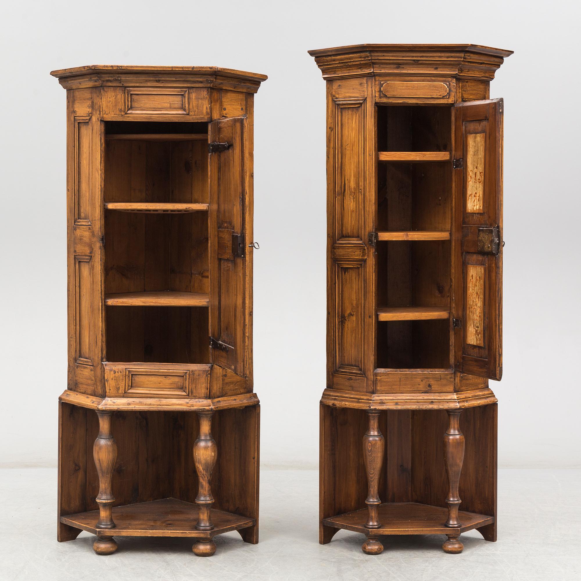 Two 18th century wooden corner cabinets.
