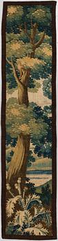 A TAPESTRY FRAGMENT, tapestry weave, ca 215,5 x 48 cm, Flanders around 1700.