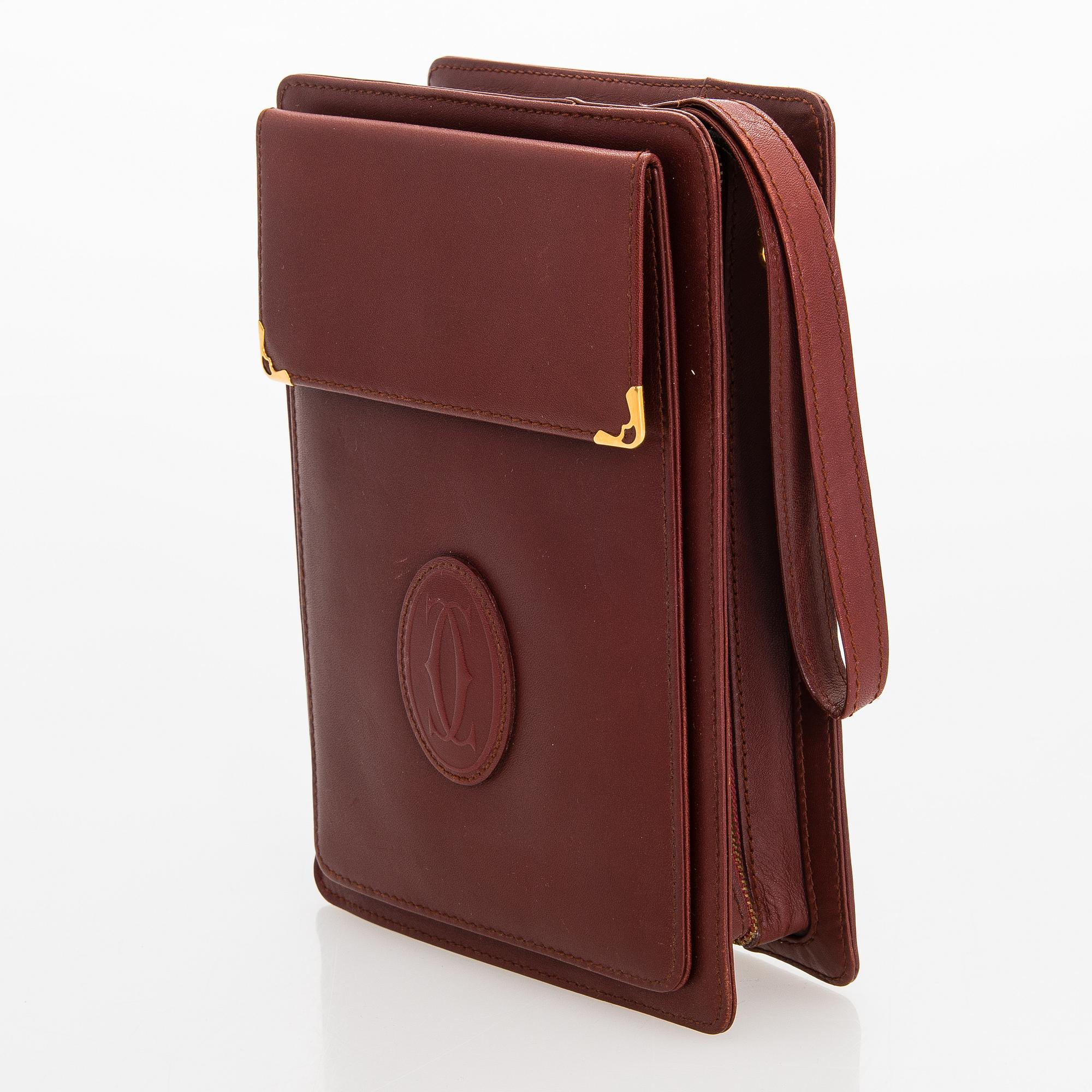 Must de Cartier bag clutch with accessories.