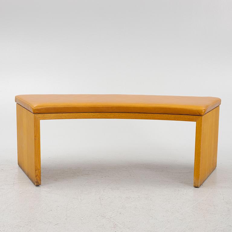 A 21st Century oak bench with leather seating.