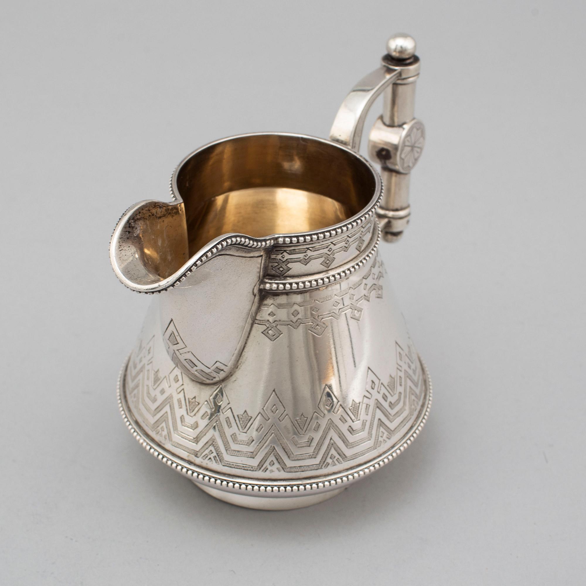 A Russian 19th century parcel-gilt silver tea pot and cream jug, mark possbly of Alexander Lokin, St. Petersburg 1893.