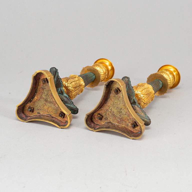 A 20th Century pair of bronze empire style candlesticks.