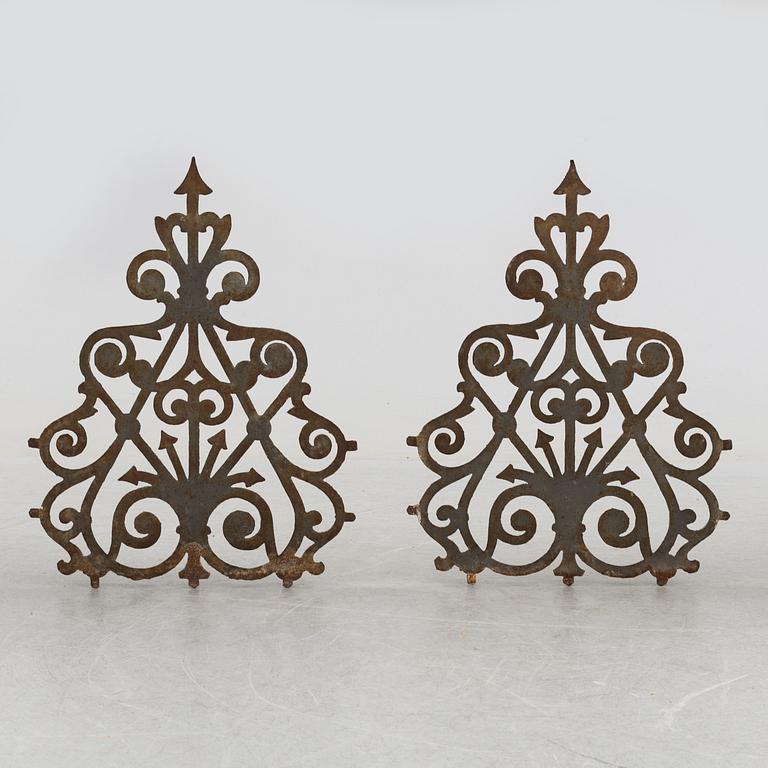 a pair of cast iron decorative pieces from the late 19th century.