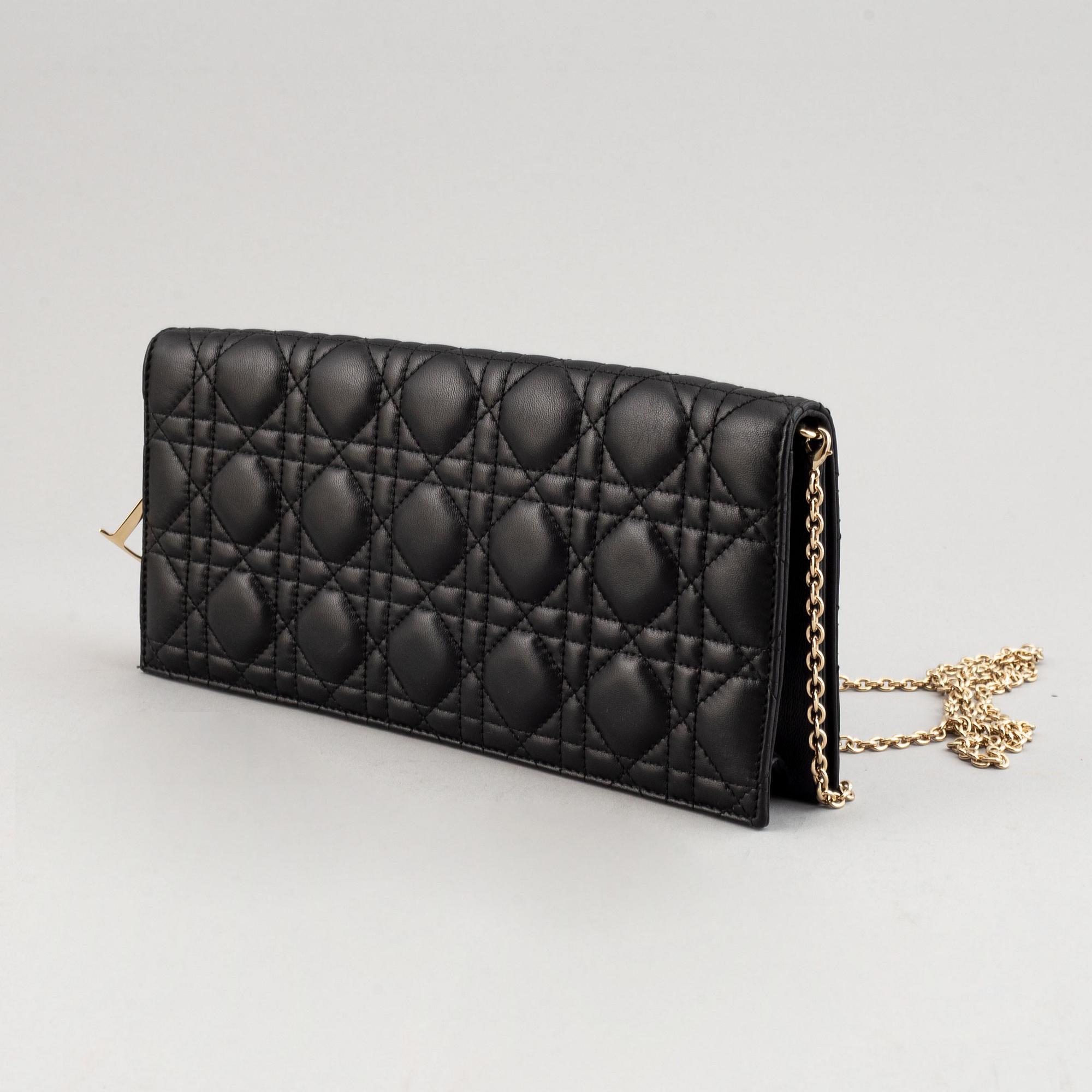 Christian Dior, a quilted leather handbag/clutch.