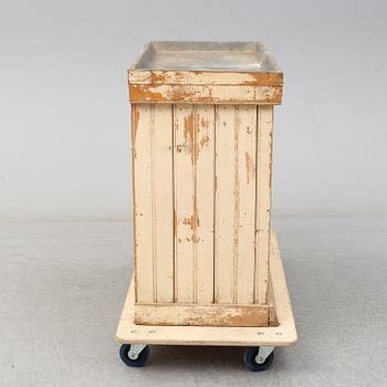 A late 19th Century cabinet with zink top.