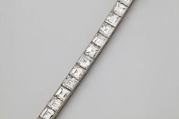A platinum bracelet set with carré cut diamonds.