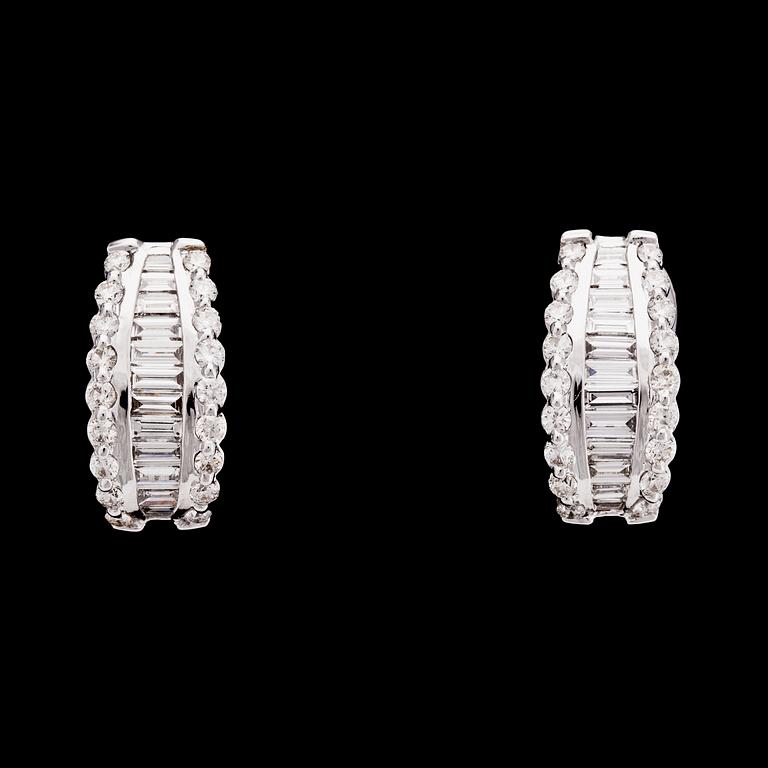 A pair of brilliant and baguette cut diamond earrings, tot. 3.55 cts.