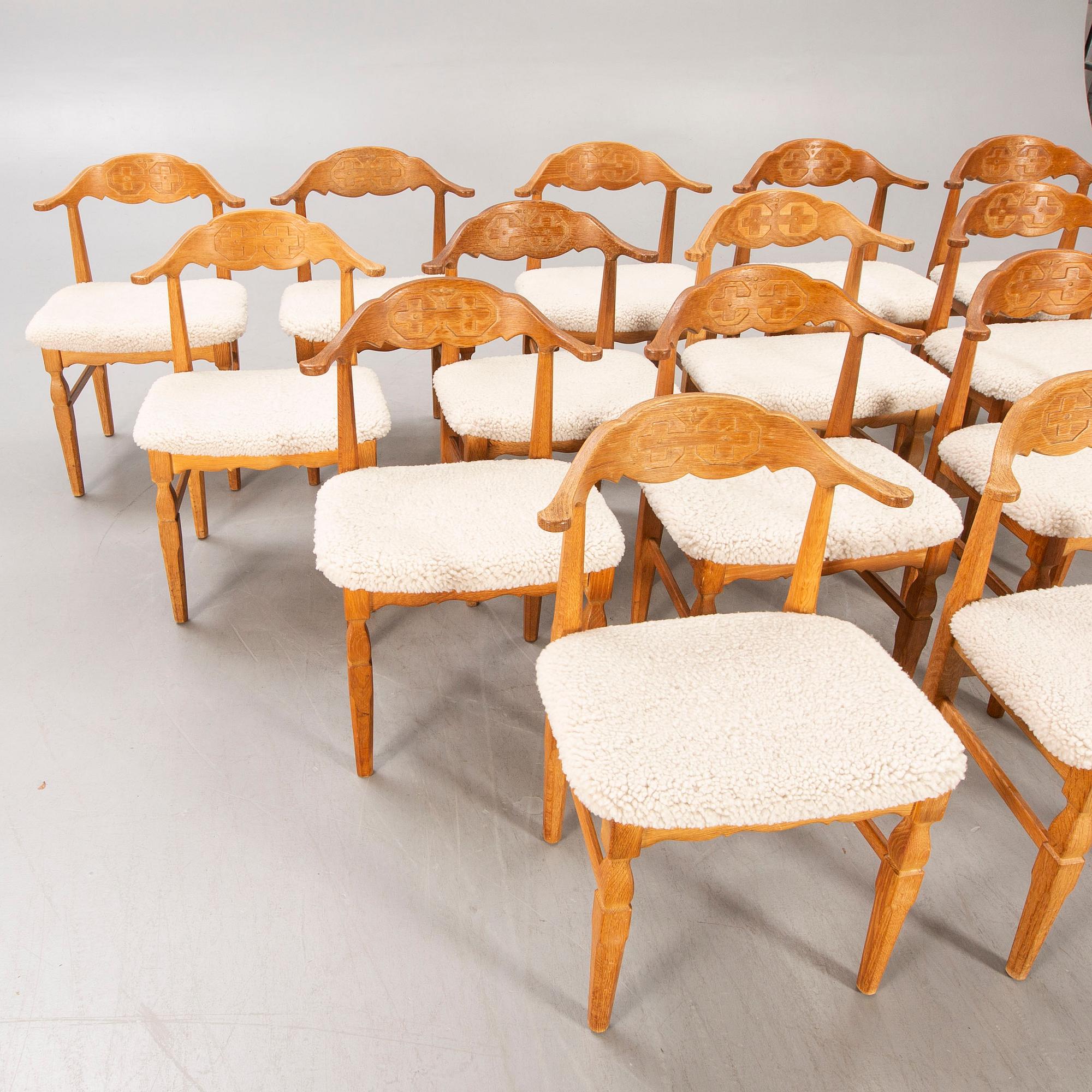 A set of 14 Henning Kjaerulf 1950s oak chairs.
