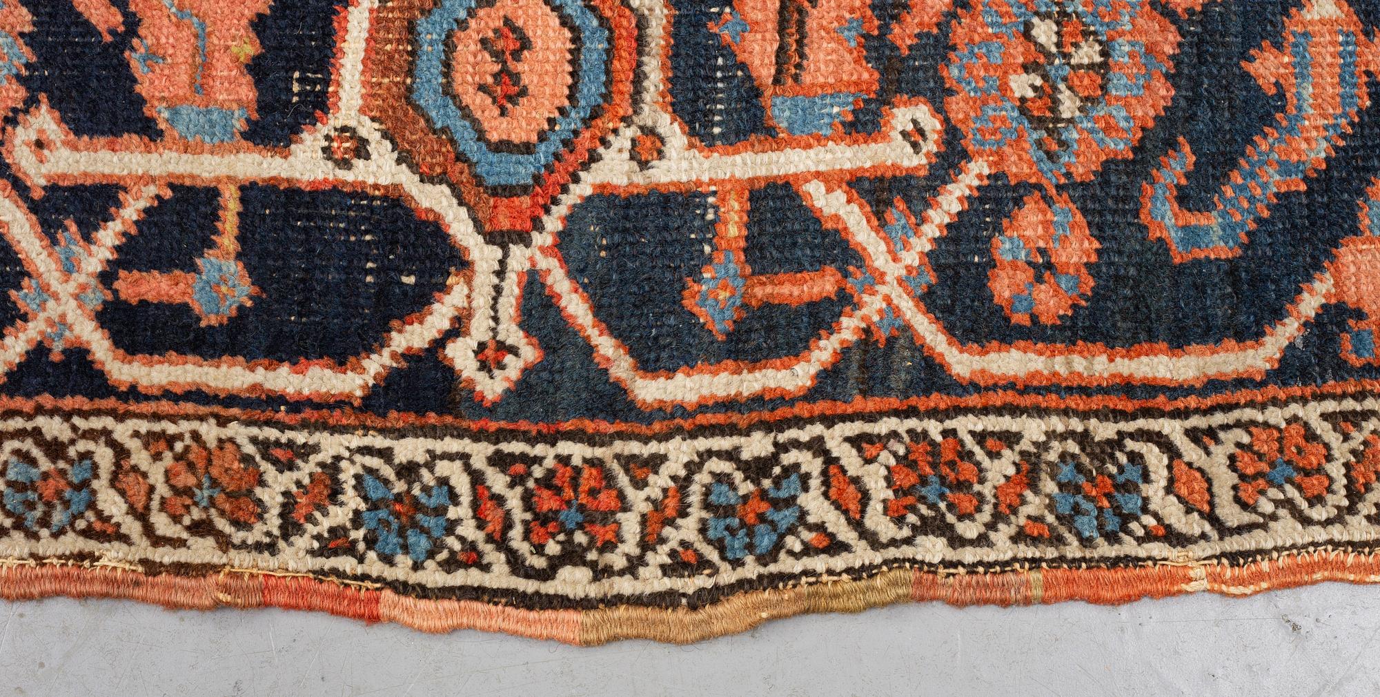 A carpet, an antique Heriz, ca 469,5-471 x 300-309,5 cm.