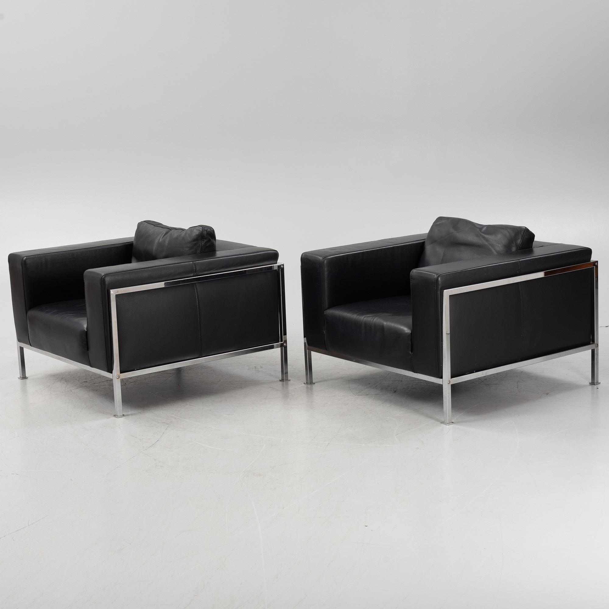 A pair of leather upholstered lounge chairs,
