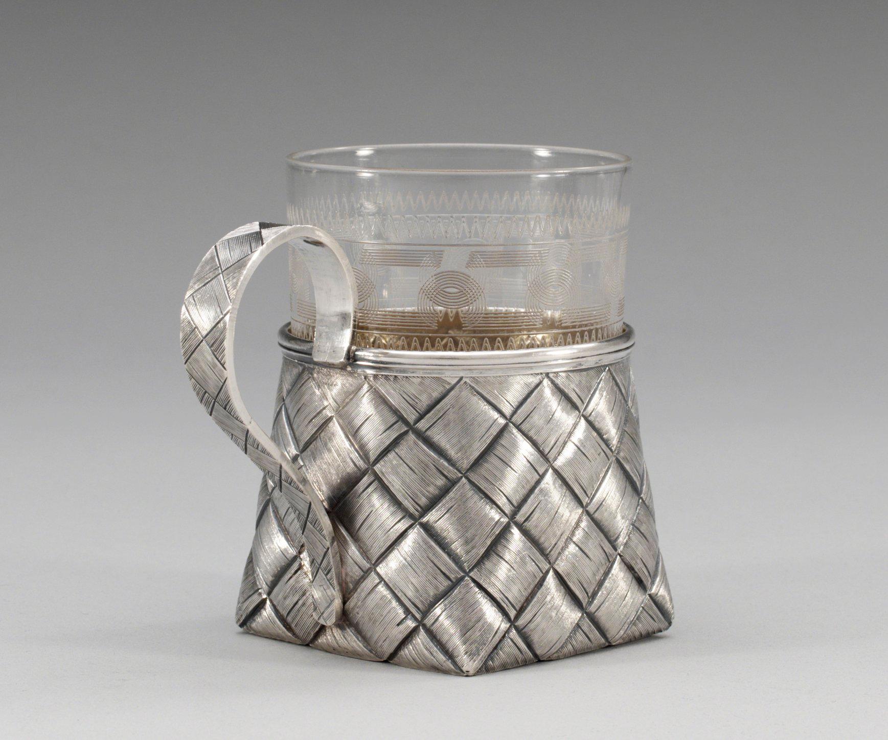 A RUSSIAN PARCEL-GILT TEA-GLASS HOLDER, makers mark of Vasily Iconikov, S:t Petersburg 1894.