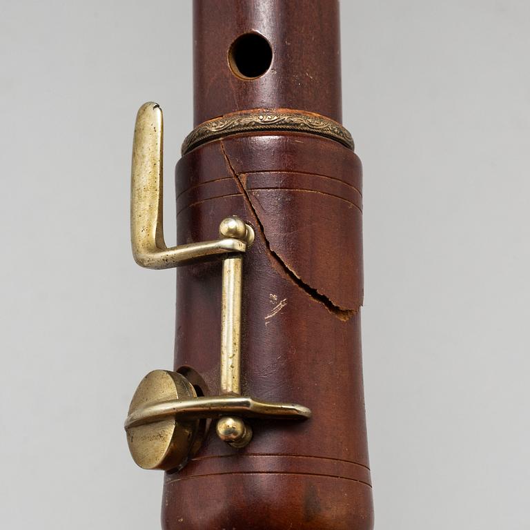 A brass shelf and two flutes, 20th century.