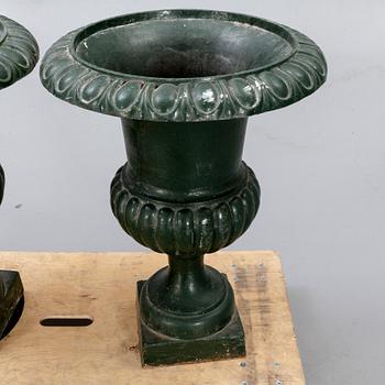 A pair of two 1990s cast iron garden urns.