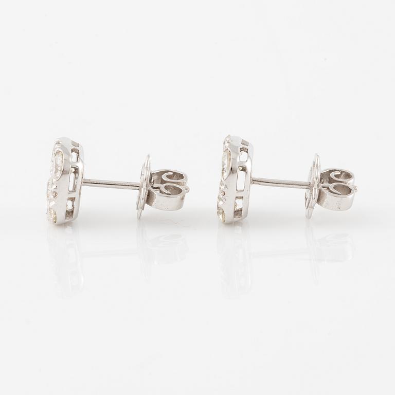 A pair of earrings in 18K white gold set with round brilliant-cut diamonds.