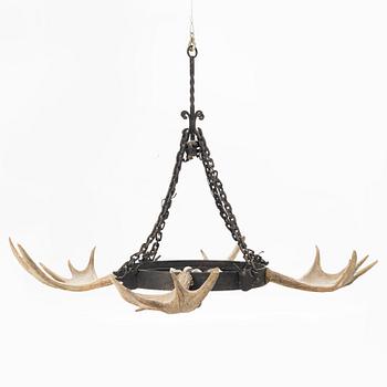 A moose horn and cast iron chandelier from around 1900.
