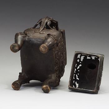 A Chinese bronze incense burner with pierced cover, Qing dynasty, 17th/18th century.