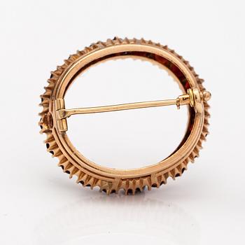 A 14K gold brooch with garnets. St. Petersburg 19th century.