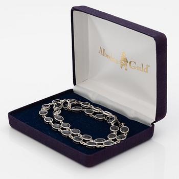 18K white gold necklace with dark sapphires.