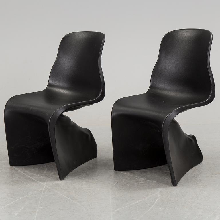 a pair of Italian black plastic chairs designed by Fabio Novembre "Him" and "Her" from the late 20th Century.