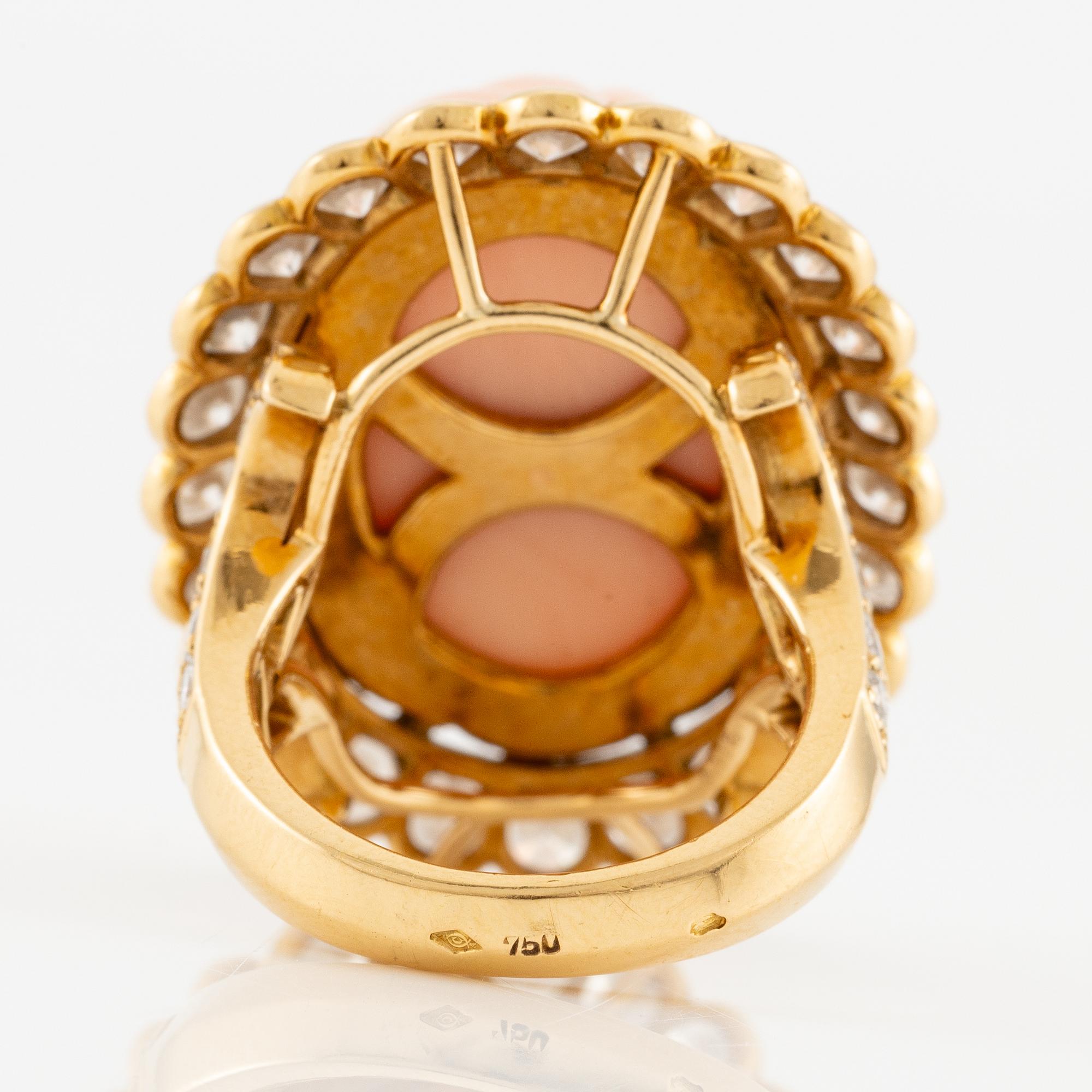 An 18K gold and coral Cartier ring set with round brilliant-cut diamonds.