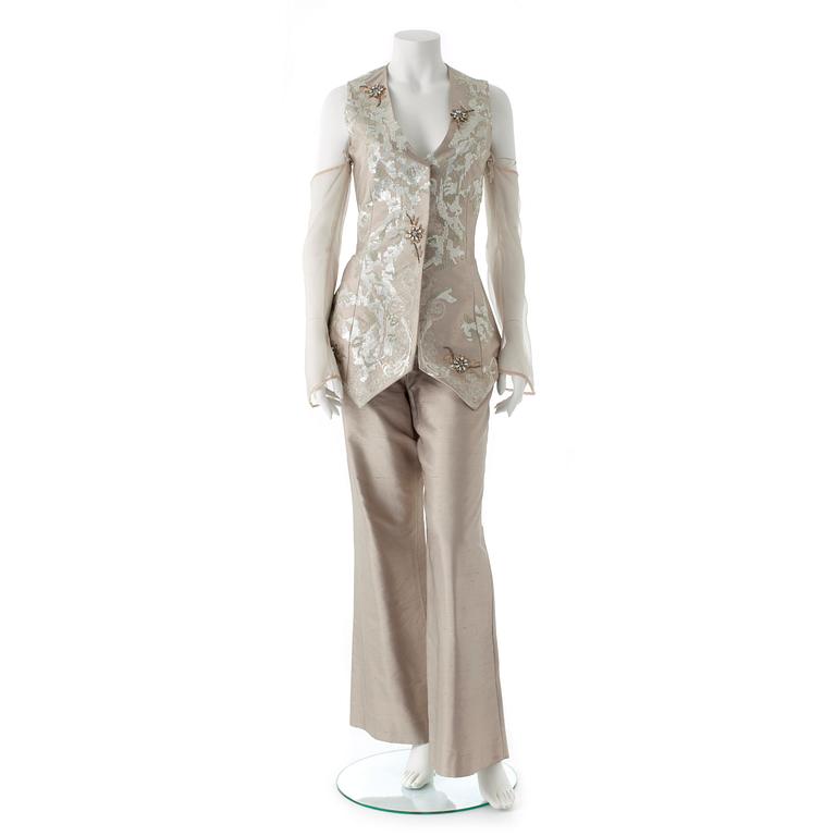 GIANFRANCO FERRÉ, a beige three-piece ensemble consisting of vest , trousers and skirt.
