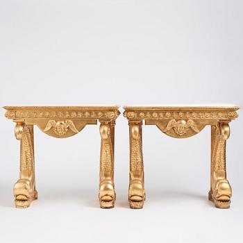 A pair of Swedish Empire carved and giltwood console tables, first half of the 19th century.