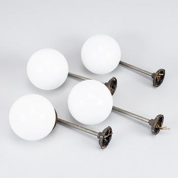 A set of four metal wall lights, first half of the 20th century.