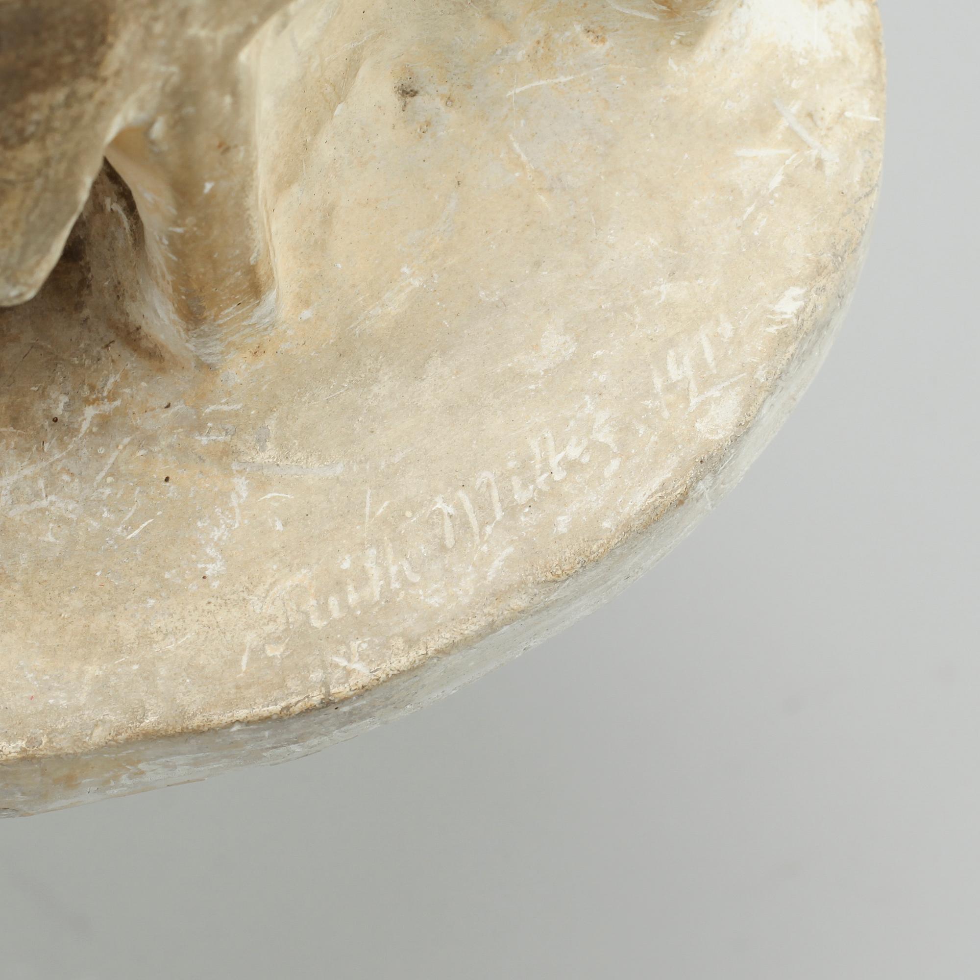 two plaster figurines, signed.