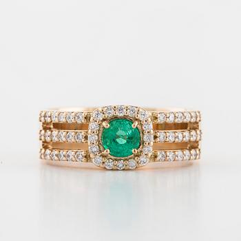 A faceted emerald and brilliant cut diamond ring.