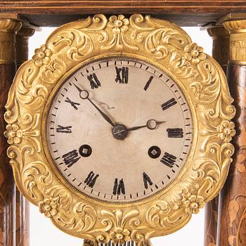 A late Empire mid 19th century veneered table clock.