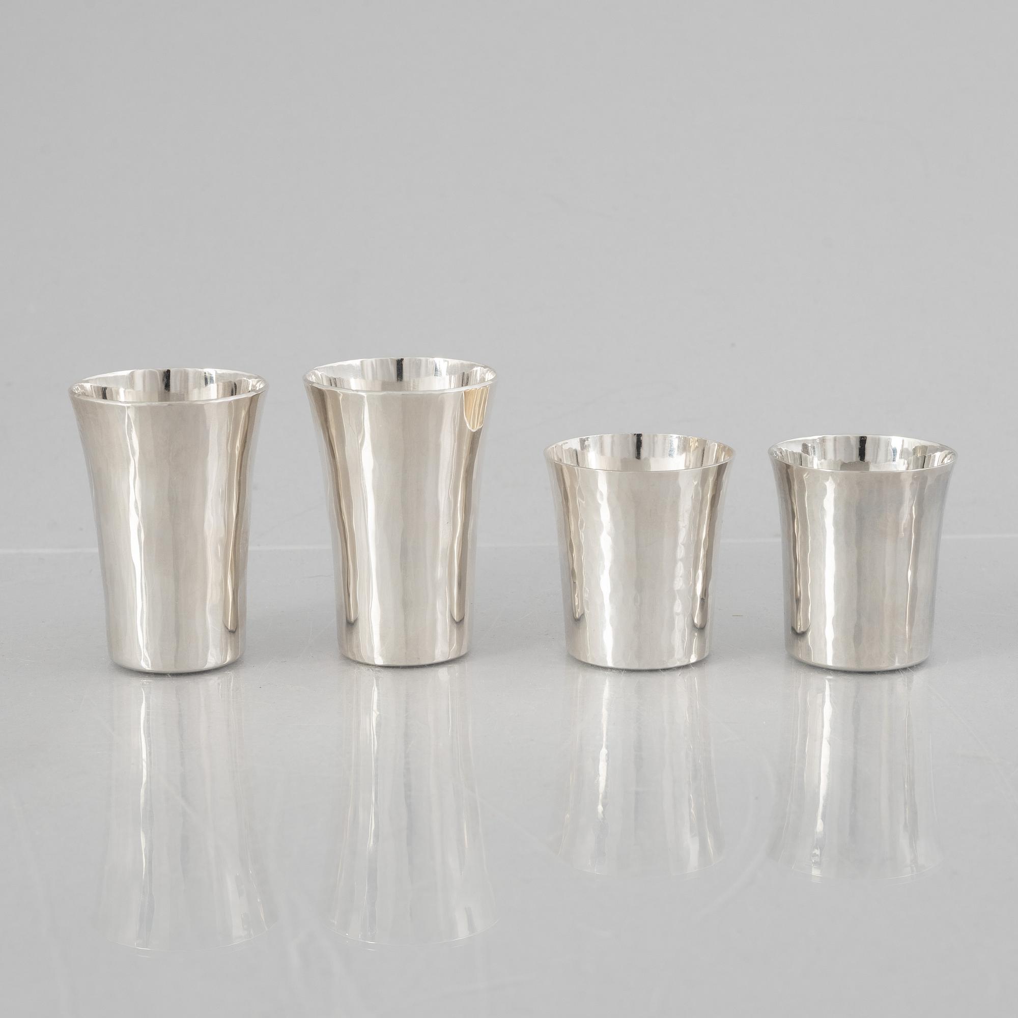 Eric Löfman, a Swedish silver candlestick, a vase and four cups, including MGAB, Uppsala 1977.