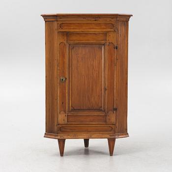 A Gustavian style pinewood corner cupboard, 19th Century.