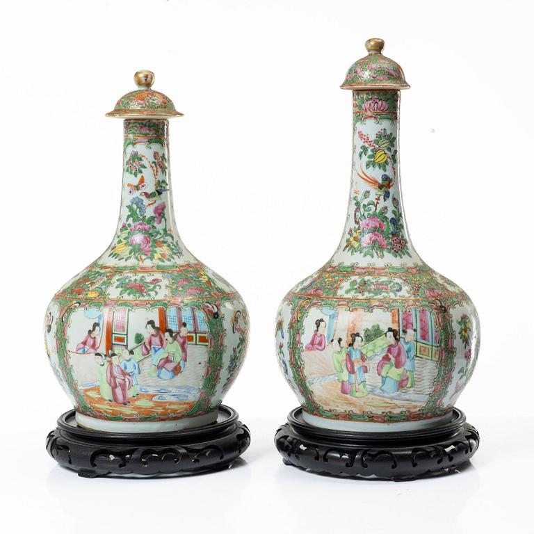 Two famille rose 'Canton' vases with covers, Qing dynasty, 19th century.