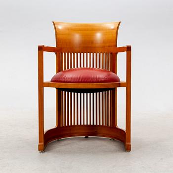 A cherry wood model 606 'Barrel' chair by Frank Lloyd Wright from Cassina.