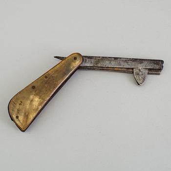 An 18th century iron folding knife for letting blood.