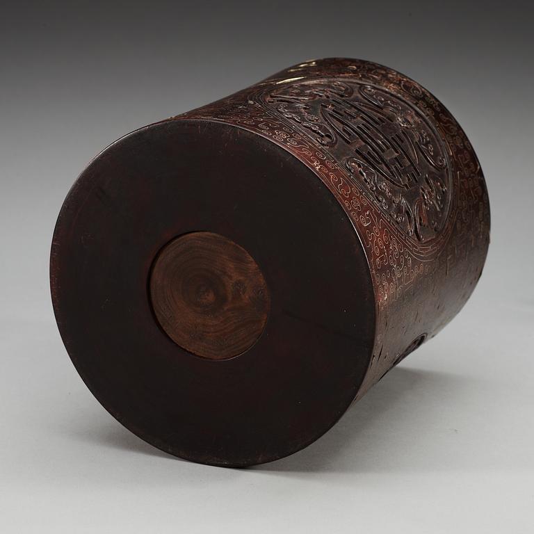 A carved wooden brush pot with metal inlay, Qing dynasty.