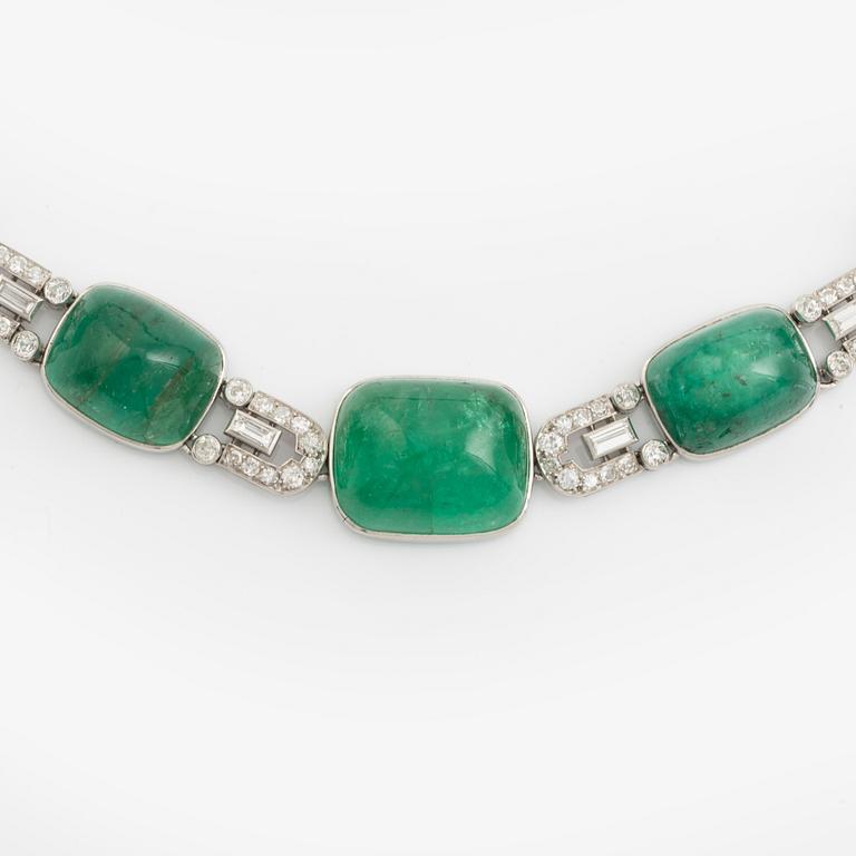 An art deco platinum necklace/bracelet combination with cabochon-cut emeralds.