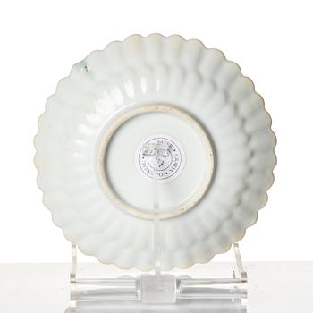 A Chinese iron red porcelain cup with saucer and a small famille verte dish, Qing dynasty, Kangxi (1662-1722).