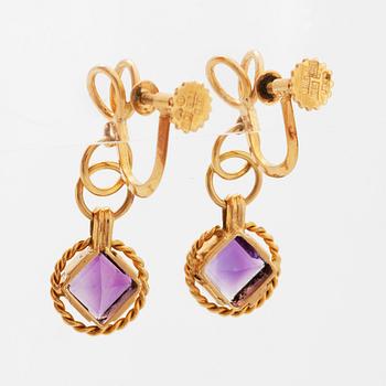 A pair of earrings and a brooch.