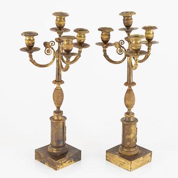 A pair of Empire ormolu four-branch candelabra, early 19th century.