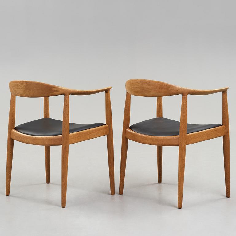 A pair of Hans J Wegner's oak 'The Chair' by Johannes Hansen, Copenhagen.