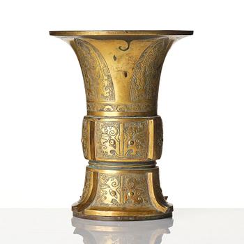 A parcel gilt/gold splashed bronze vase, Gu, 17/18th century.