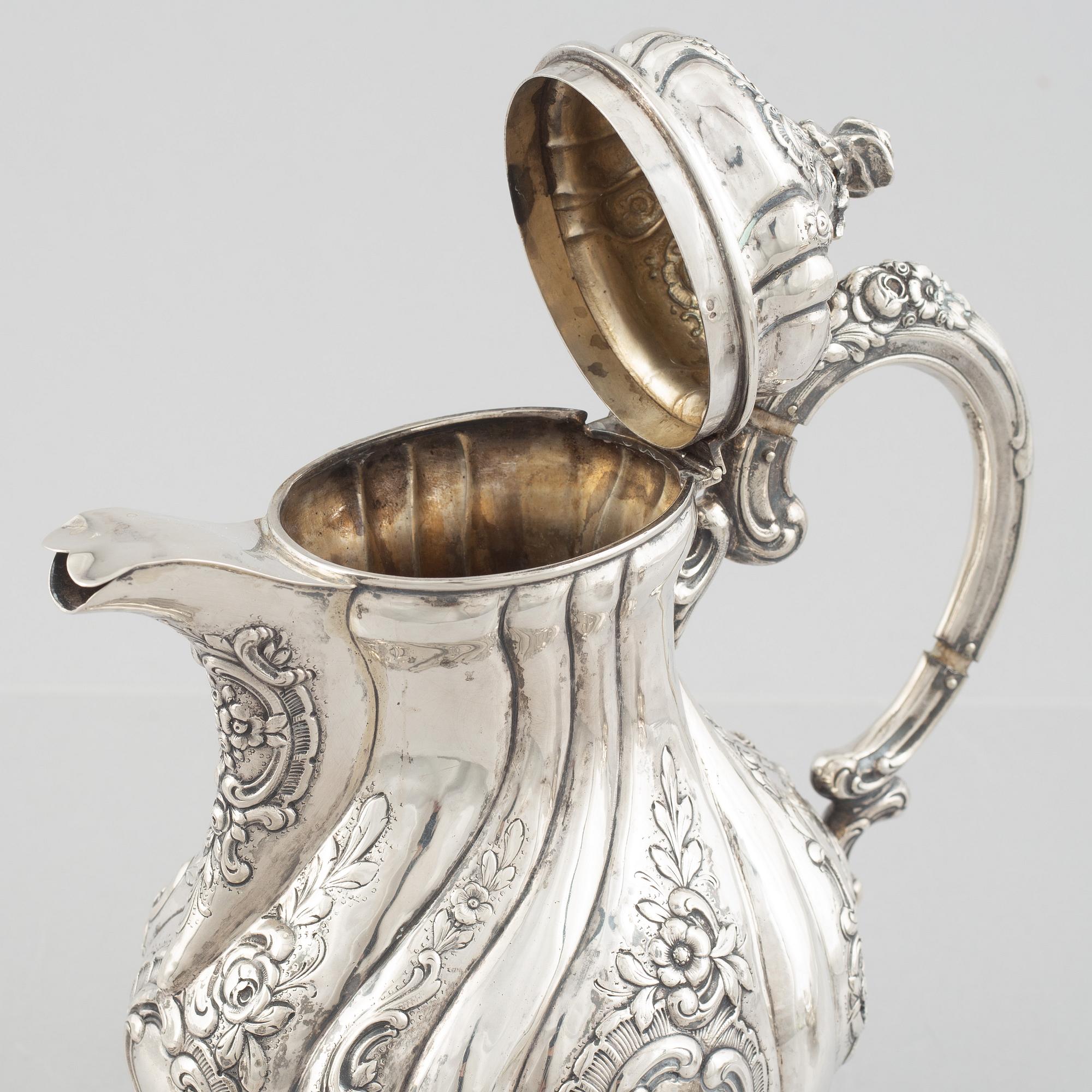 A Rococo-style silver coffee pot, creamer and sugar bowl, 20th Century.