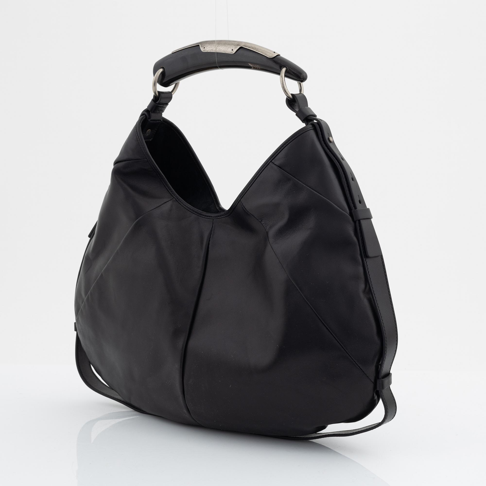 Yves Saint Laurent, a black leather and horn hobo bag.