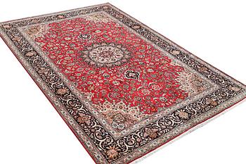 A Tabriz carpet, part silk, 50 raj, c. 325 x 208 cm.